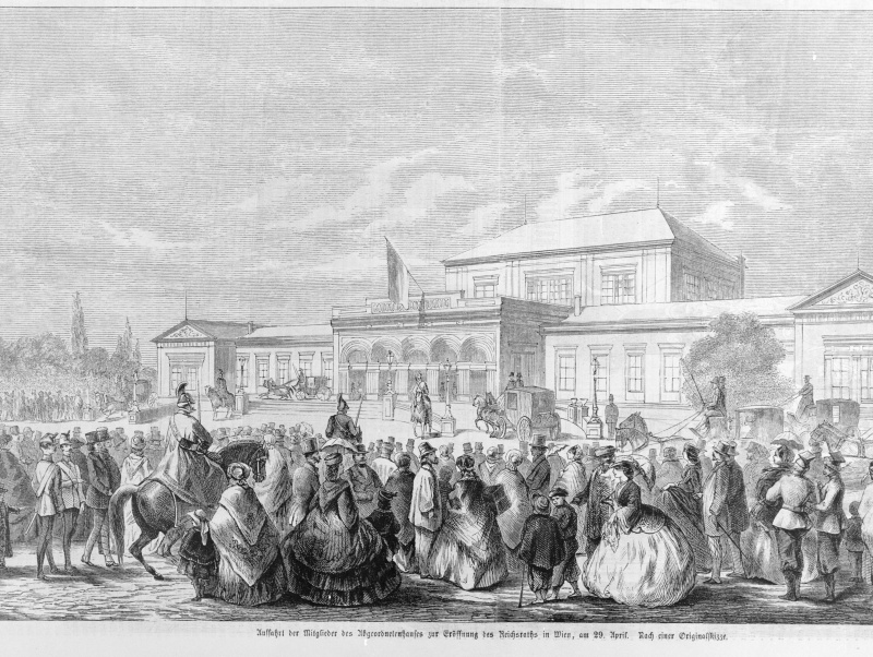Am 29. April 1861 fahren die Mitglieder des Abgeordnetenhauses zur Eröffnung des Reichsrates vor dem kurz zuvor errichteten Abgeordnetenhaus (\x22Bretterbude\x22, \x22Schmerlingtheater\x22) beim Schottentor vor.