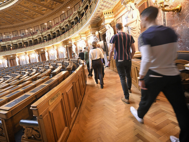 People during a tour of Parliament in historic Meeting Hall