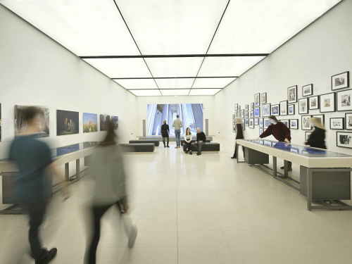 Auditorium: Blick auf die Medientische "Medien und Demokratie" und "Plattformen – Die neuen Öffentlichkeiten im Internet", die LED-Wand sowie die Fotoausstellungen "Global Peace Photo Award" (links) und "Zeitzeugen". Besucher:innen