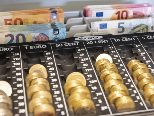 Kassa gefüllt mit EuroMünzen und EuroScheinen