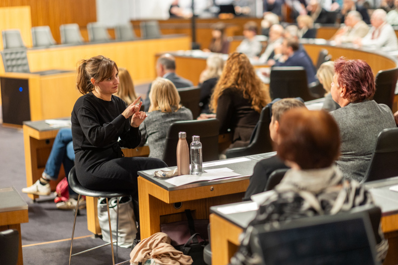 Blick Richtung Veranstaltungsteilnehmer:innen - Dolmetscherin bei der Simultanübersetzung