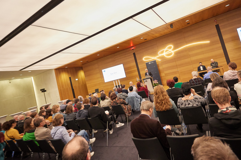 Eröffnungsworte Parlamentsdirektor Harald Dossi. Blick Richtung Veranstaltungsteilnehmer:innen