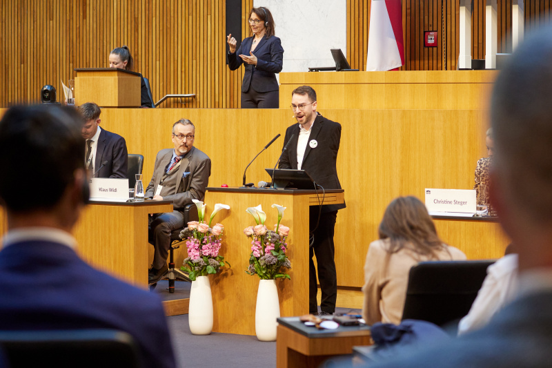 Am Redner:innenpult: Moderator Andreas Onea - ORF