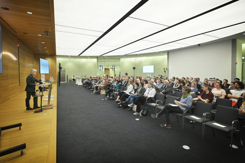 Eröffnungsworte. Parlamentsdirektor Harald Dossi. Blick Richtung Veranstaltungsteilnehmer:innen