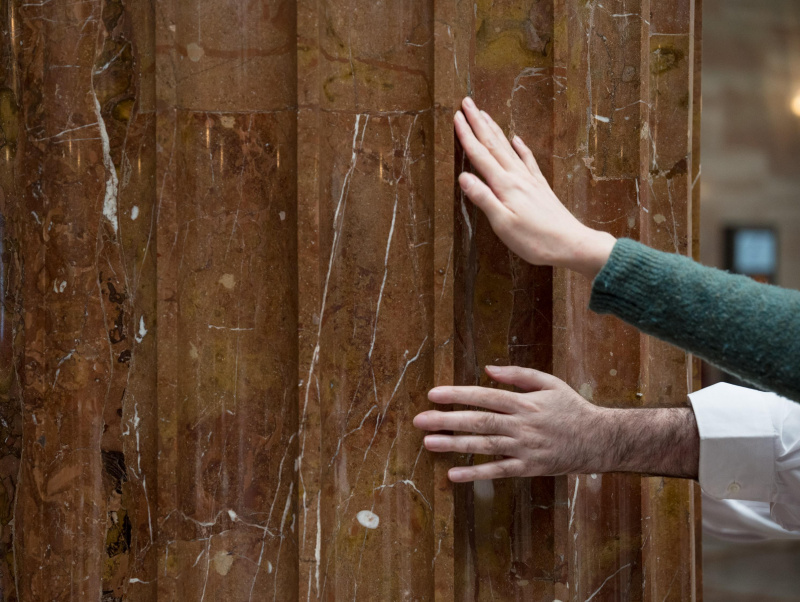 Veranstaltungsteilnehmer:innen ertasten eine Säule