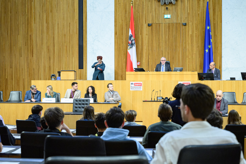 Einleitende Worte durch Nationalratspräsident Walter Rosenkranz (FPÖ) am Präsidium. Auf der Regierungsbank von Links: Nationalratsabgeordneter Ralph Schallmeiner (GRÜNE), Nationalratsabgeordnete Ines Holzegger (NEOS), Nationalratsabgeordneter Paul Stich (SPÖ), Nationalratsabgeordnete Margreth Falkner (ÖVP), Nationalratsabgeordneter Maximilian Weinzierl (FPÖ)