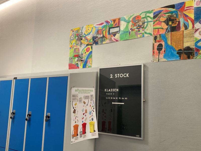 Wegweiser und Spinte am Gang in einer Schule