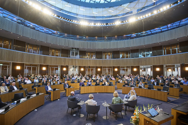 Podiumsgespräch. Blick Richtung Veranstaltungsteilnehmerinnen und -teilnehmer