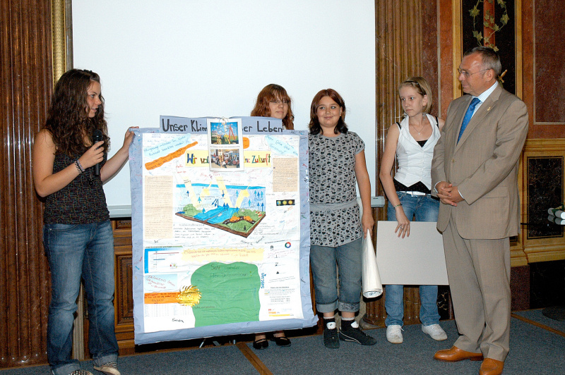 Schüler überreichen ein Klimaschutzplakat an Alfred Gusenbauer.