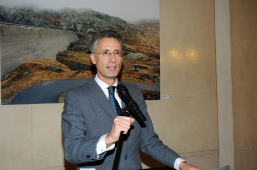 Parlamentsdirektor Georg Posch am Rednerpult. Im Hintergrund ein Bild der Künstlerin Margherita Spiluttini.