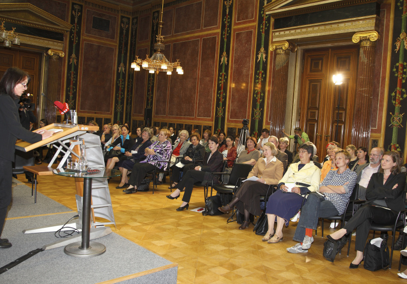 Univ.Prof.in Mag. Dr. Gabriella Hauch - Universitaet Linz am Rednerpult mit Blickrichtung VeranstaltungsteilnehmerInnen.
