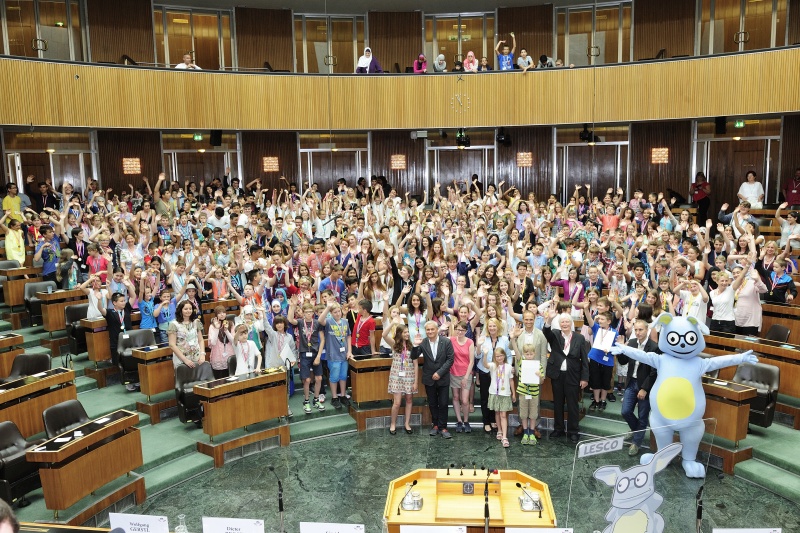 Gruppenfoto der Demokratieprofis mit ParlamentarierInnen. Erste Reihe v.li.: Schülerin mit den Nationalratsabgeordenten Christian Lausch (F), Sigrid Maurer (G), Nationalratspräsidentin Doris Bures (S) Nationalratsabgeordneter Wolfgang Gerstl (V) und Botschafter a.D. Wolfgang Wolte