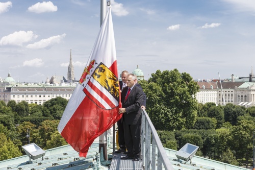 Bundesratspräsident Gottfried Kneifel (V) und Parlamentsbedienstete beim Hissen der Fahne Oberösterreichs am Parlamentsdach