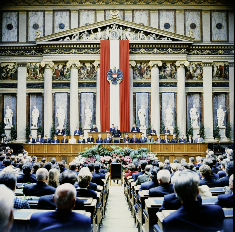 Blick Richtung Regierungsbank und Präsidium während der Ansprache von Bundeskanzler Franz Vranitzky (S) (am Rednerpult).

Am Präsidium von links: Bundesratsvizepräsident Herbert Schambeck (V), Dritter Nationalratspräsident Herbert Haupt (F), Bundesratspräsident Jürgen Weiss (V), Nationalratspräsident Heinz Fischer (S), Zweiter Nationalratspräsident Heinrich Neisser (V), Bundesratsvizepräsident  Walter Strutzenberger (S), Parlamentsdirektor Heinz Wasserbauer.

Auf der Regierungsbank von links.: Staatssekretär im Bundeskanzleramt Gerhard Schäffer (V), Staatssekretär im Bundesministerium für Öffentliche Wirtschaft und Verkehr Martin Bartenstein (V), Staatssekretär im Bundesministerium für Finanzen Johannes Ditz (V), Familienministerin Sonja Moser (V), Verteidigungsminister Werner Fasslabend (V), Gesundheitsministerin Christa Krammer (S), Umweltministerin Maria Rauch-Kallat (V), Wirtschaftsminister Wolfgang Schüssel (V), Außenminister Alois Mock (V), Vizekanzler und Unterrichtsminister Erhard Busek (V), Innenminister Caspar Einem (S), Verkehrsminister Viktor Klima (S), Finanzminister Andreas Staribacher, Frauenministerin Helga Konrad (S), Sozialminister Franz Hums (S), Justizminister Nikolaus Michalek, Wissenschaftsminister Rudolf Scholten (S), Landwirtschaftsminister Wilhelm Molterer (V), Staatssekretärin im Bundeskanzleramt Brigitte Ederer (S), Staatssekretär im Bundeskanzleramt Karl Schlögl (S).